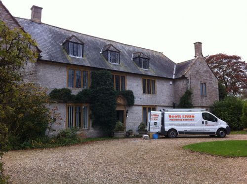 Our van outside a stone manor house on a job