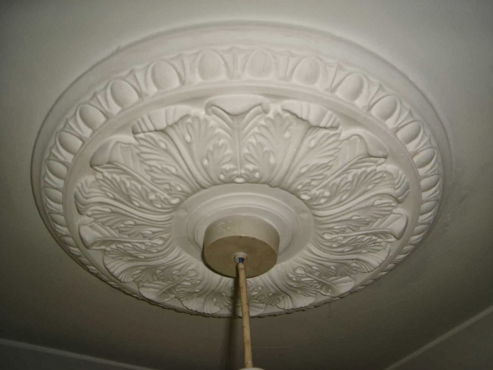 An ornate ceiling rose restored in a smooth plastered ceiling