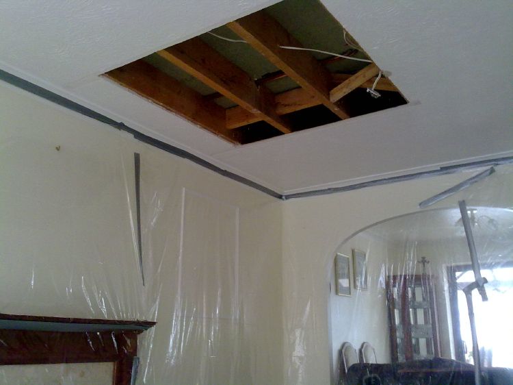Cutting out a damaged ceiling after a water leak