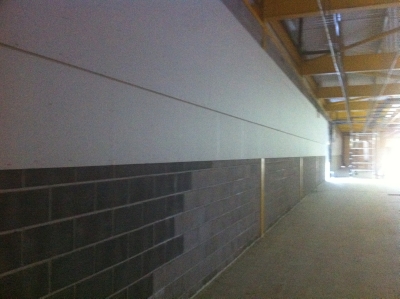 A long retail unit wall boarded and part plastered
