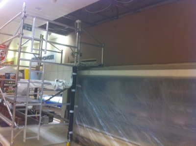 Scaffold tower against a freshly plastered commercial wall
