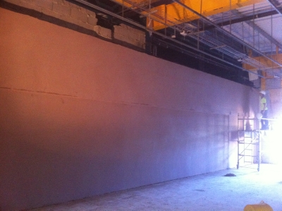 A wide commercial wall plastered end to end