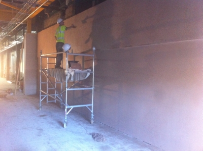 Scaffold tower and finished plaster in a large unit