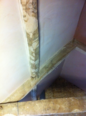 Vaulted ceiling with old timbers being plastered