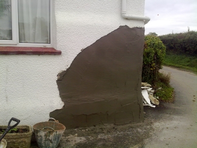 Exterior render patch on a cottage wall