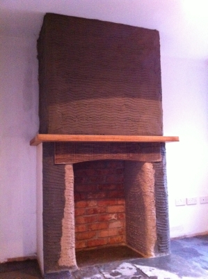 Chimney breast rendered around a brick fireplace