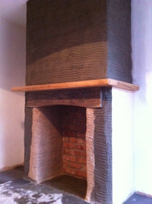 Fireplace with oak mantel after plastering